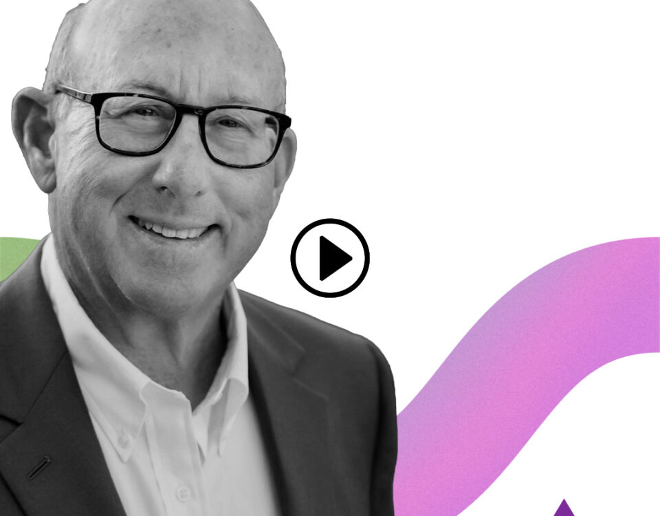Video thumbnail: grayscale portrait of a smiling man in a suit and glasses, with a pink-purple curved background and Vertex logo; play button overlaid.
