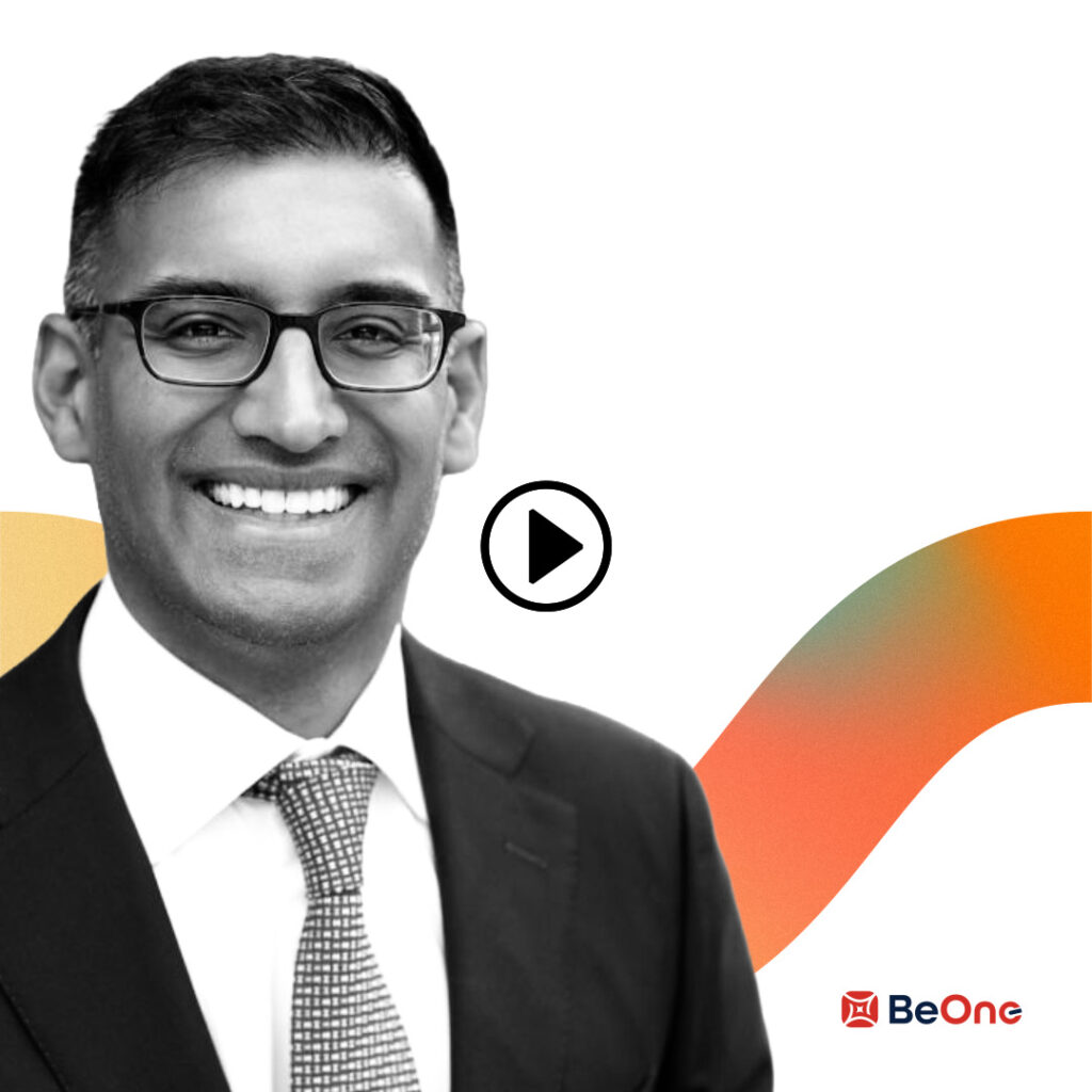 Smiling man in a suit and glasses on a video thumbnail with a play button, BeOne logo in the corner.